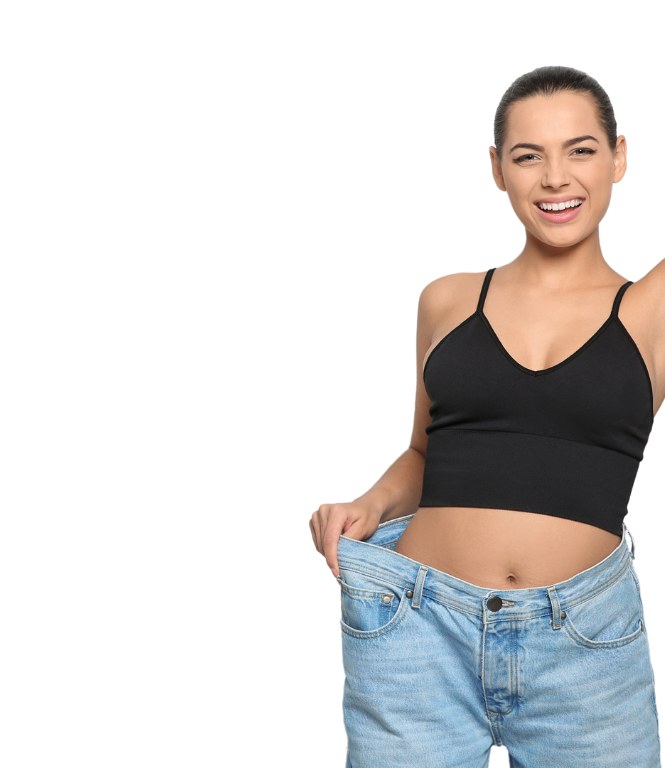 Woman showing major weight loss in loose-fitting jeans after the ProGen programme